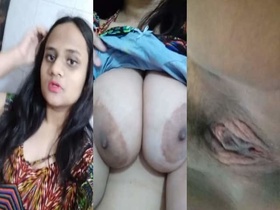 An Indian woman with large breasts and a vagina records herself