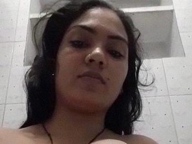 Self-loving bhabhi in the bathroom, capturing her naked body in a video