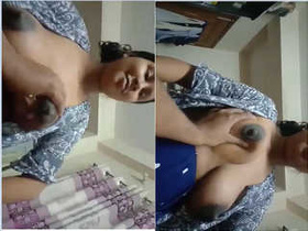 Husband admires wife's big breasts in bedroom