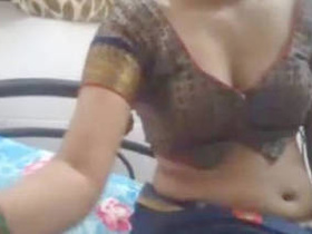 Indian girl in saree and blouse performs a cam show