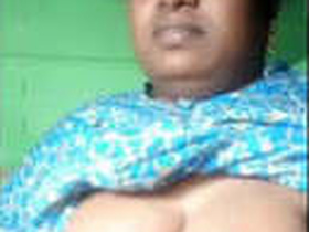 Mature woman flaunts her ample bosom in rural setting