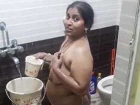 Watch Aunt Dishania's big boobs bounce in the bathroom