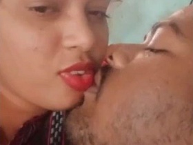 Indian couple kiss passionately in village setting