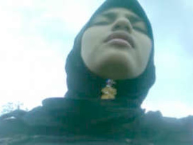 A sweetly dressed Muslim girl reveals her breasts and genitalia