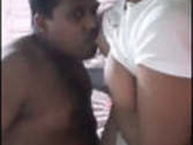Lovers with big breasts engage in passionate kissing and breast play